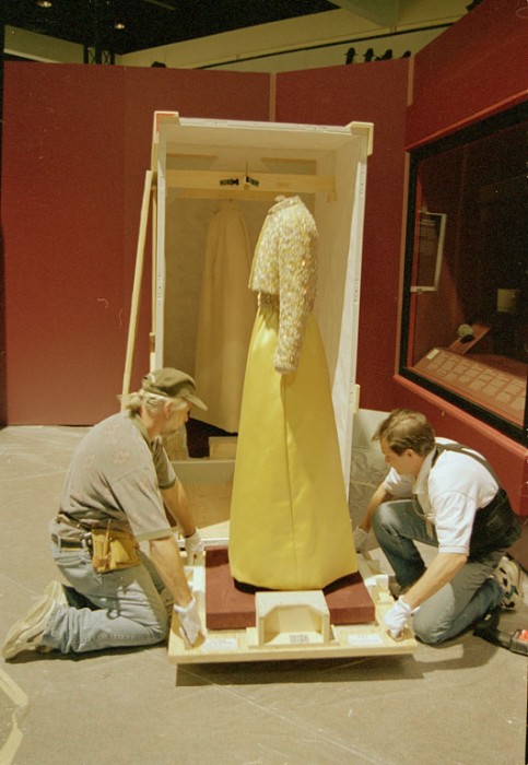 The inaugural gown worn by Patricia Ryan Nixon in 1969 is being unpacked from its shipping crate at the Los Angeles Convention Center. The Convention Center was the first stop of the "America's Smithsonian" exhibition national tour celebrating the Smithsonian's 150th anniversary. The exhibition opened in Los Angeles on February 9, 1996.