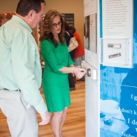 Visitors enjoy the "New Harmonies" exhibit on its opening night at the Birthplace of Country Music Museum, March 2015. (Photo by Haley Hensley, BCMM)