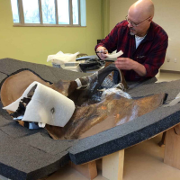 Preparator Alan Zdinak sets up to build a storage jacket for the ground sloth's pelvis.