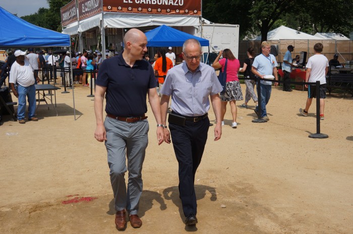 Al Horvath, left, and Secretary Skorton stroll through the Folklife Festival on their way to the picnic. (Photo by John Gibbons)