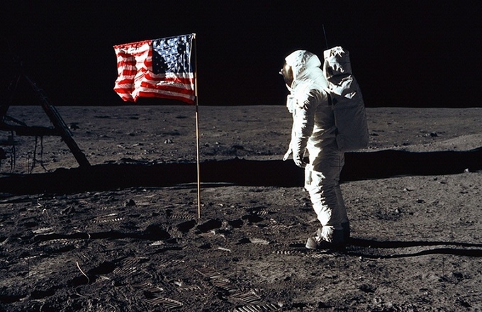 Astronaut Buzz Aldrin poses for a photograph beside the deployed United States flag during an Apollo 11 Extravehicular Activity (EVA) on the lunar surface. Astronaut Neil Armstrong, commander, took this picture with a 70mm Hasselblad lunar surface camera.