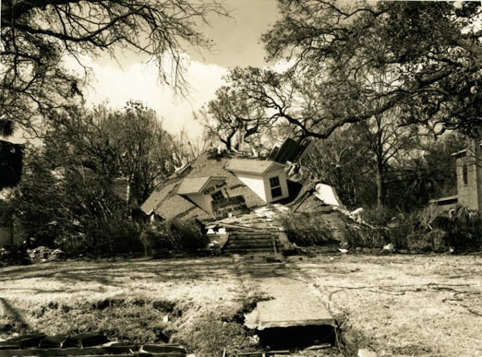 Smashed House, Katrina, Gulf Coast, Mississippi, 2005. This house, destroyed by Hurrican Katrina, has completely collapsed under its roof, which is still largely intact.  Photograph by Melody Golding, Melody Golding "Katrina" Photographic Documentation Project, 2005-2008, Archives Center, National Museum of American History. Gift of the artist.