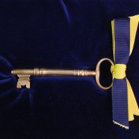 The tradition of passing the Smithsonian key to the incoming Secretary originated for the 1964 induction of S. Dillon Ripley as the eighth Secretary of the Smithsonian. In lieu of the administration of an oath of office, outgoing Secretary Leonard Carmichael proposed a key-passing ceremony based on similar ones frequently used in the inauguration of university presidents. The key was presented in 1964 to Ripley by Chief Justice Earl Warren, Chancellor of the Smithsonian. The large brass key dates to the mid-19th century.