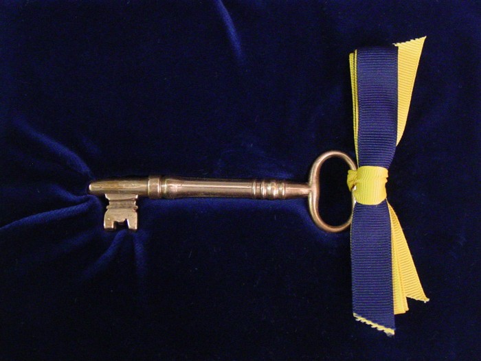 The tradition of passing the Smithsonian key to the incoming Secretary originated for the 1964 induction of S. Dillon Ripley as the eighth Secretary of the Smithsonian. In lieu of the administration of an oath of office, outgoing Secretary Leonard Carmichael proposed a key-passing ceremony based on similar ones frequently used in the inauguration of university presidents. The key was presented in 1964 to Ripley by Chief Justice Earl Warren, Chancellor of the Smithsonian. The large brass key dates to the mid-19th century.