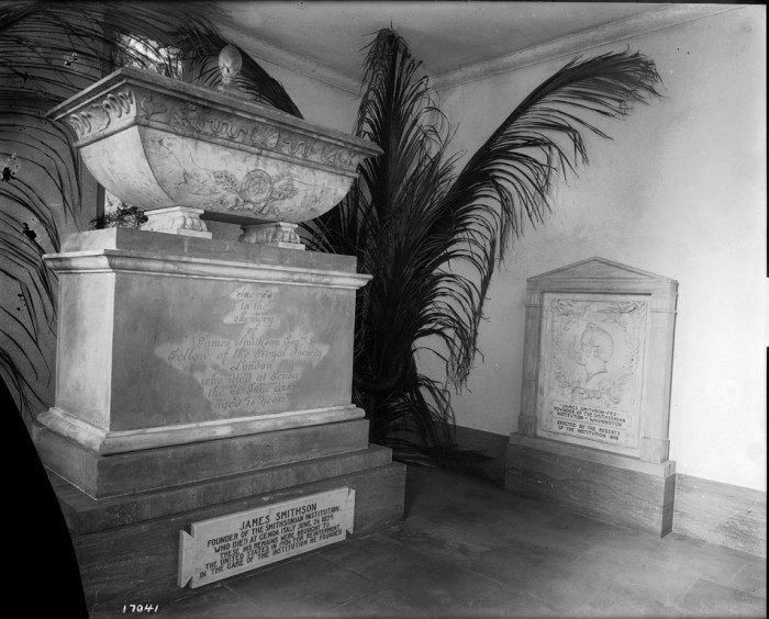 Crypt containing the body of founder James Smithson in the North Tower entrance of the Smithsonian Institution Building or Castle. Smithson's remains were brought to the United States by Smithsonian Regent Alexander Graham Bell in 1904, when the Protestant Cemetery in Genoa, Italy, where Smithson was buried, was to be moved. Many plans were made for an elaborate memorial to the Institution's benefactor, but the lack of an appropriation dictated a more modest course. Smithson's marker from the Italian gravesite was incorporated into the room, and a gate was fashioned from pieces of the fence that had surrounded the site. Architects Hornblower and Marshall redesigned the room to give it a more somber classical feeling, replacing the ceiling, windows, and the floor. (Photographer unknown, 1905)