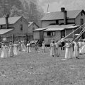 Cropped photo of women around May poles