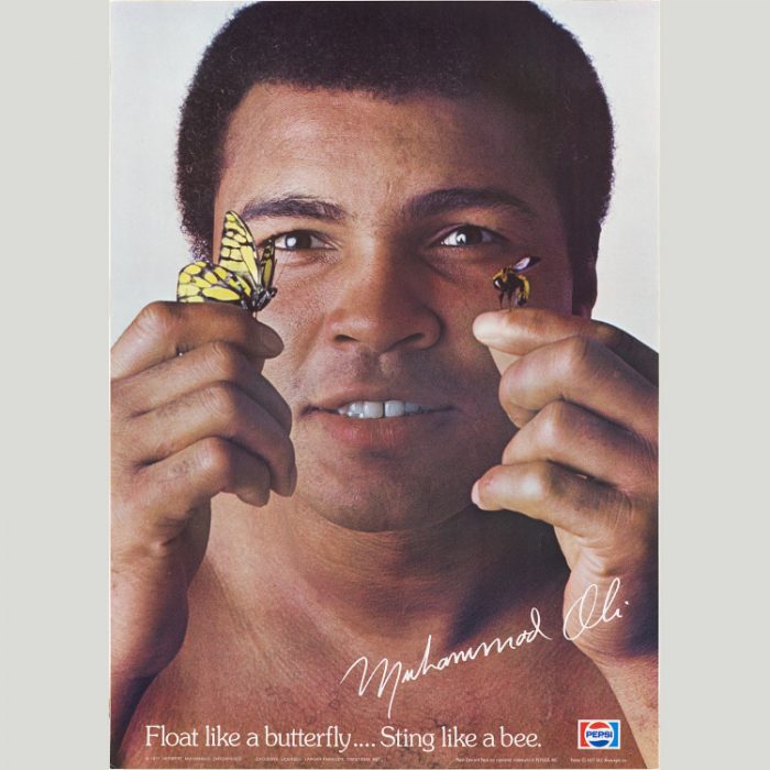 Photo of Ali with a butterfly and a bee