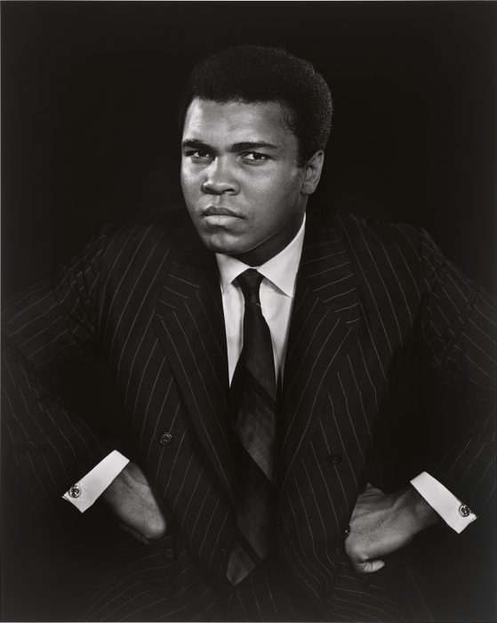 Black and white portrait of Ali with hands onhips