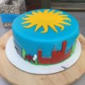 Layer cake iced with blue and yellow Smithsonian logo.