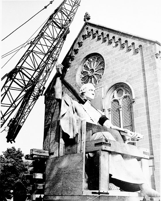 Statue being lifted by crane