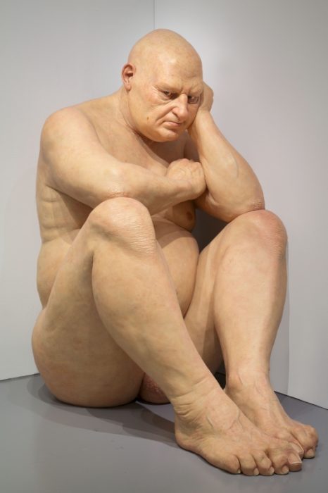 Sculpture of large, seated, naked man