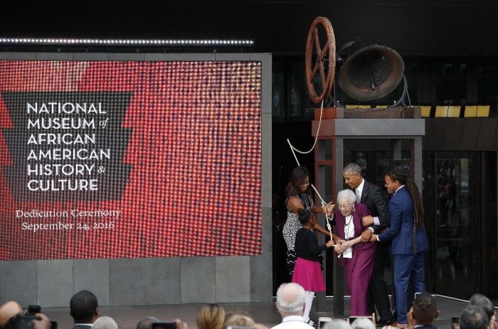 Obamas with Bonner, NMAAHC logo prominent on background