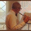 Dr David Skorton playing the flute in his office