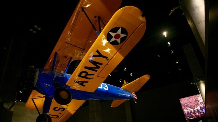 Blue and yellow plane suspended from ceiling