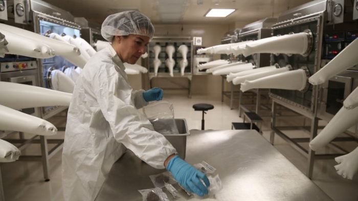 Corrigan wearing protective clothing in clean room