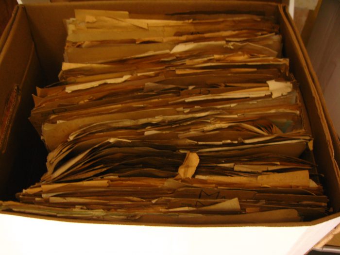 Damaged documents in cardboard file boxes