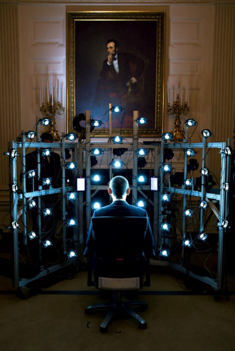 Obama seen from the back facing rows of lights