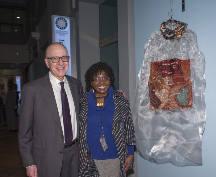 Skorton and artists pose next to her work in exhibition gallery