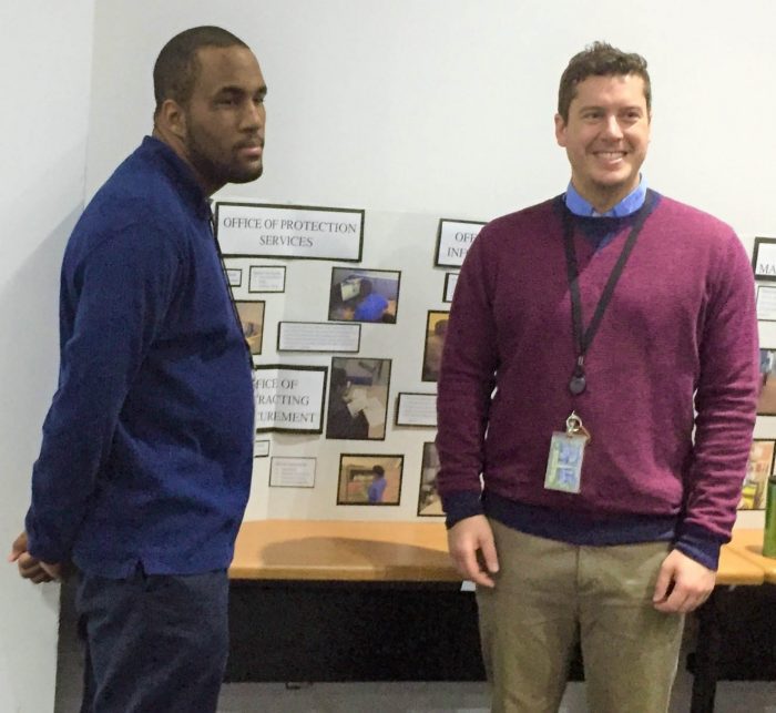 Taylor and Garon stand in front of Project Search display table