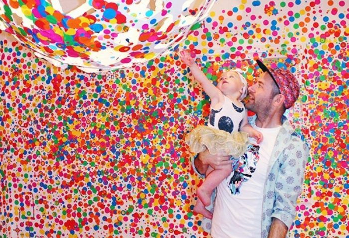 Man with young child in polka-dot room