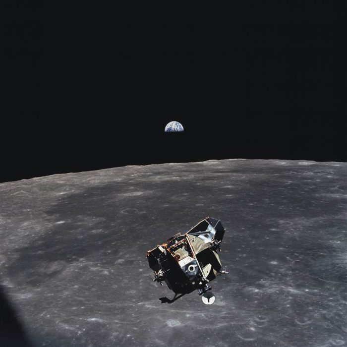 module suspended in space above moon's surface