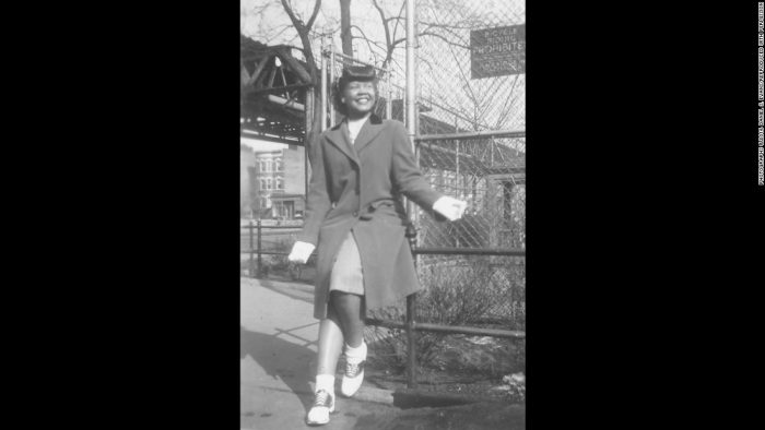 Young African American girl in gloves, coat and saddle shoes