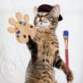 Cat in beret holding palette and brush