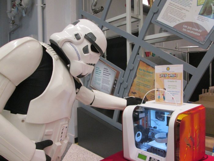 Person in stormtrooper costume looks at display