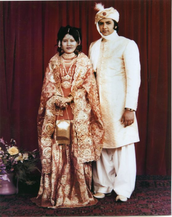 Formal portrait of Pakistani couple in wedding apparel