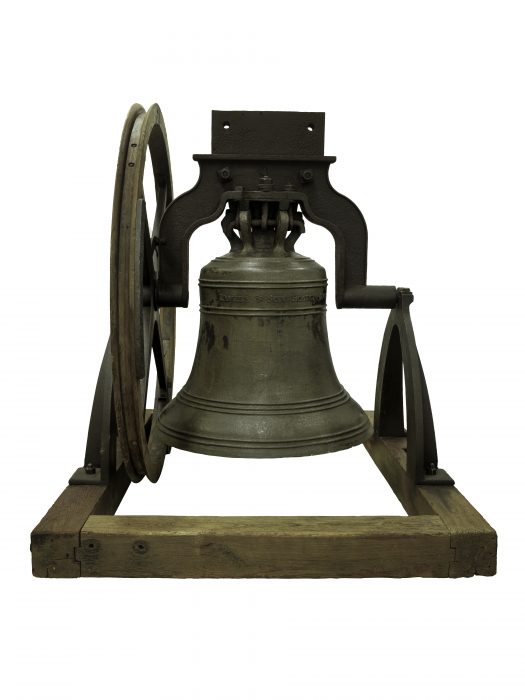 bronze bell on wooden stand