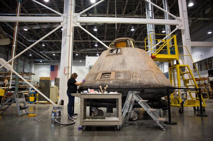 Curator working on Apollo 11 capsule