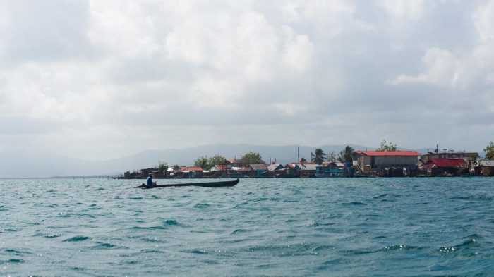 Fishing boat approaches village