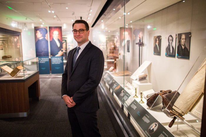 Curator standing among display cases