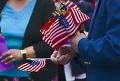 person holding small American flags