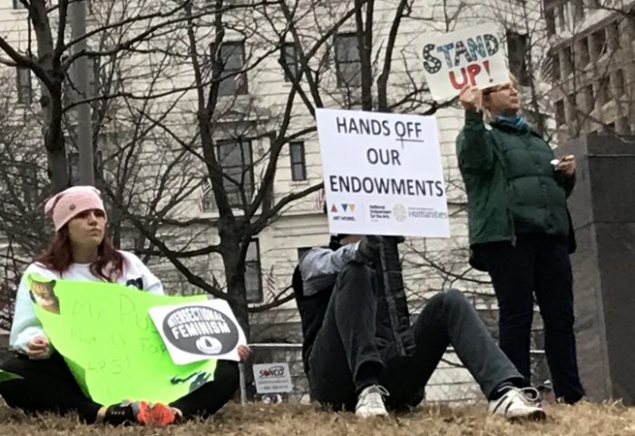 Protesters holding signs