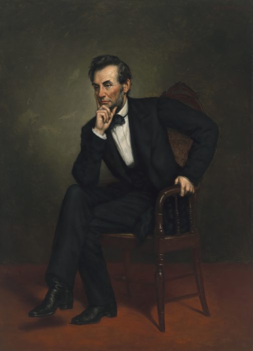 portrait of Lincoln seated on chair with chin in hand