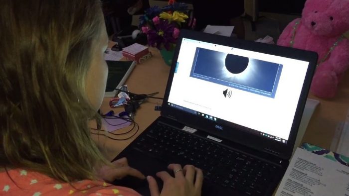 Girl using laptop with eclipse app