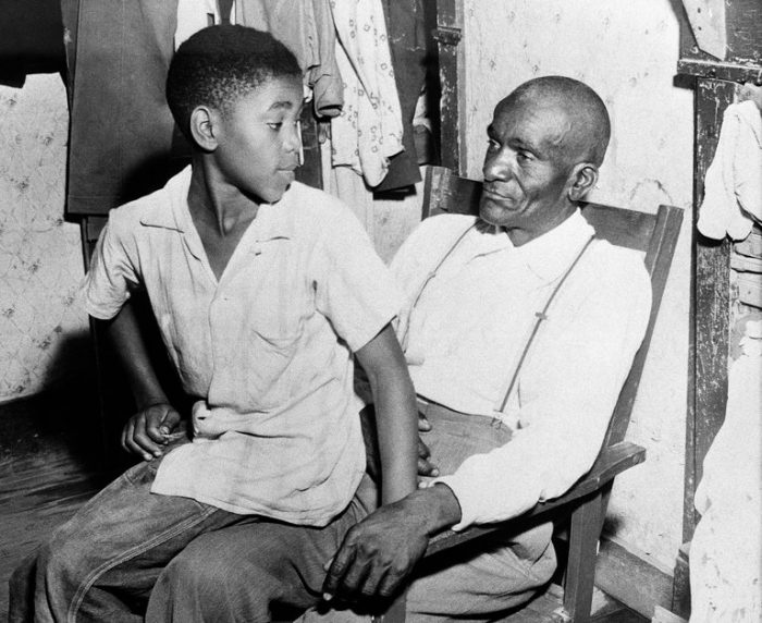 Young boy sitting on father's lap