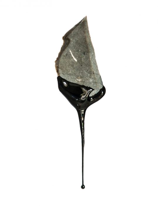 Stone ax dripping tar