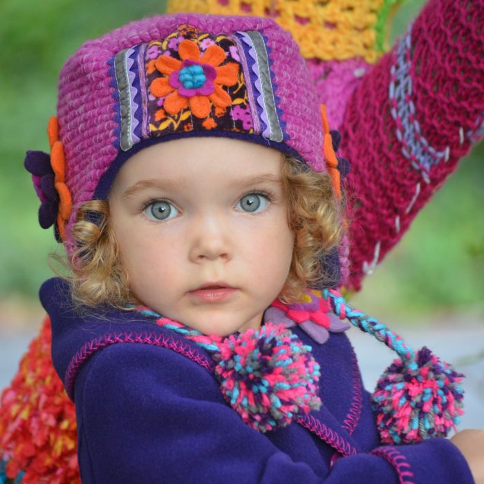 Child wearing colorful hat and jacket