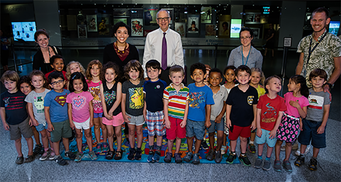 Group shot of class with adults arrayed behind them