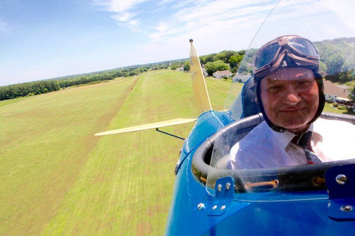 Pilot in open cockpit seen from the front