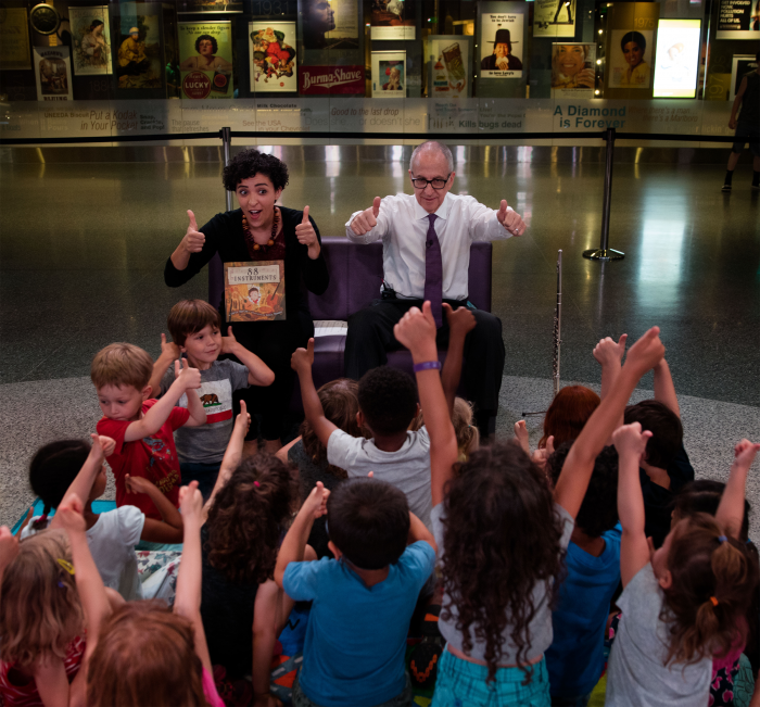 Gorey and Skorton in front of class making thumbs up sign