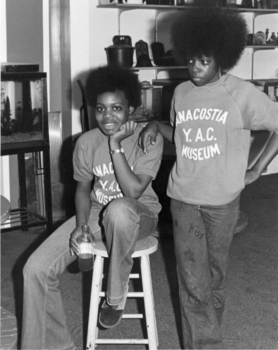Two kids with afros wearing sweatshirts