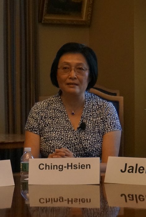 Wang at table with name card