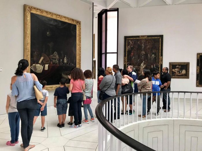 Museum visitors looking at painting