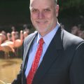 Formal photo of Kelly with flamingos in background