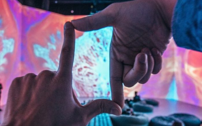 hands in foreground framing picture