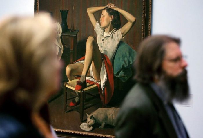 Visitors in front of painting showing young girl with legs apart and skirt pulled up