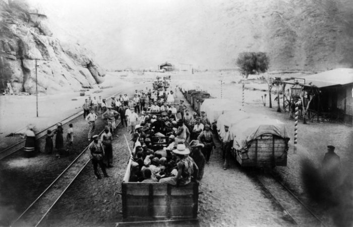 B&W photo of people in rail cars